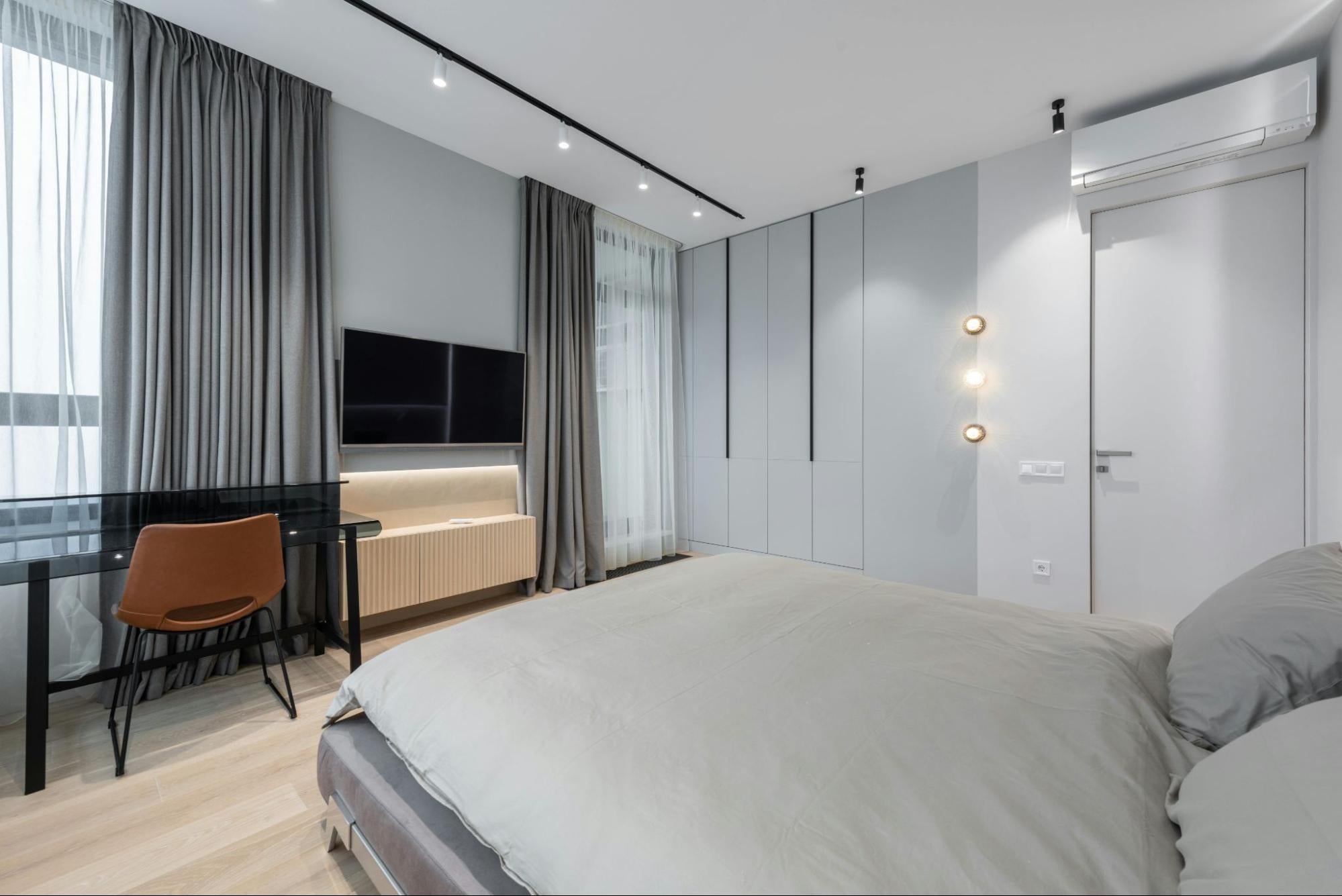 Minimalist bedroom with air conditioner on wall