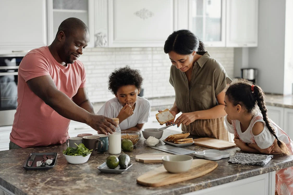 A family making breakfast in the kitchen