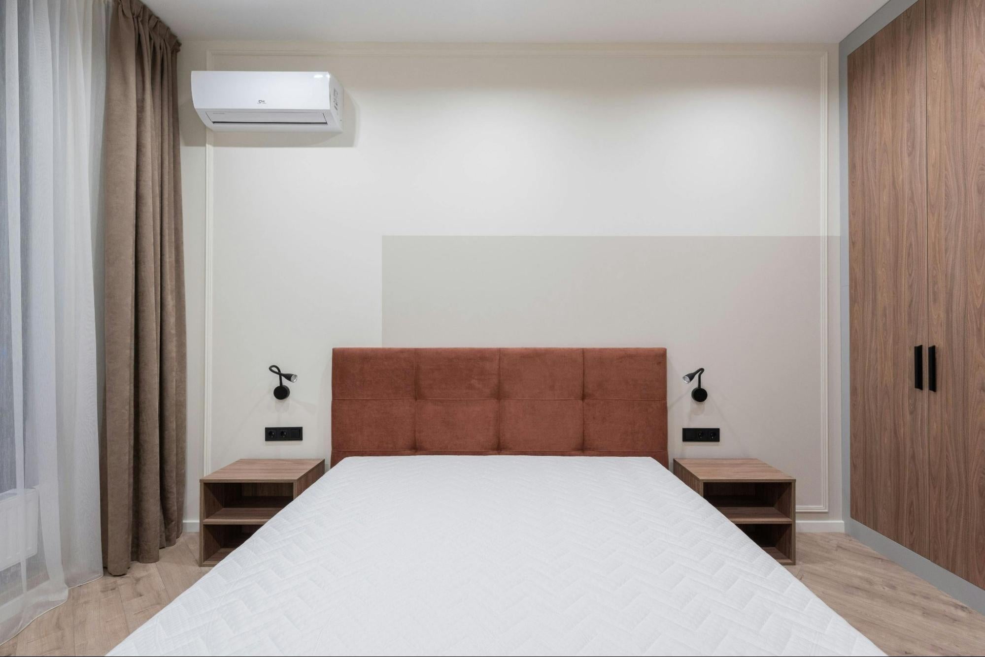 Mini split air conditioner in clean minimalist bedroom